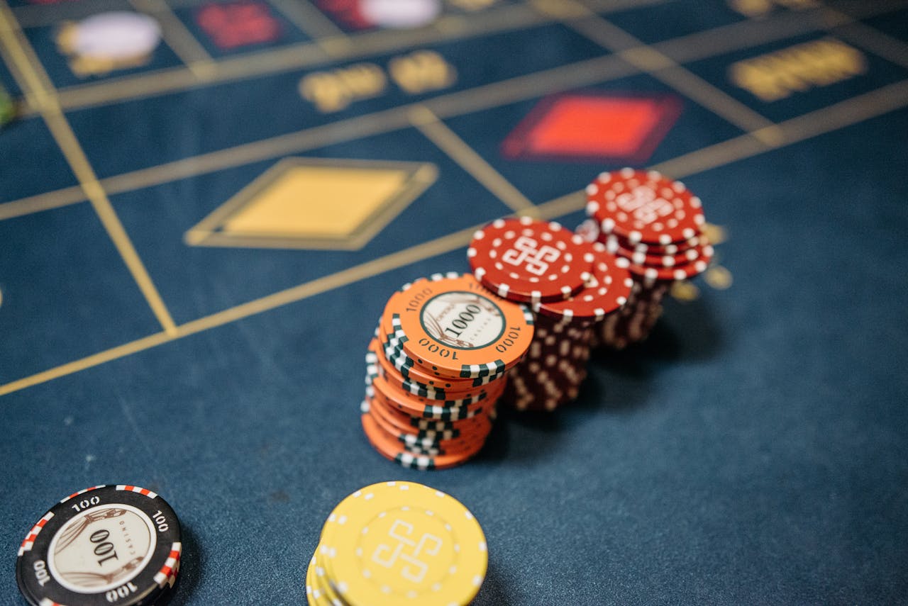 Overview & Official Info Stacked casino chips on a vibrant roulette table, symbolizing chance and gaming excitement.
