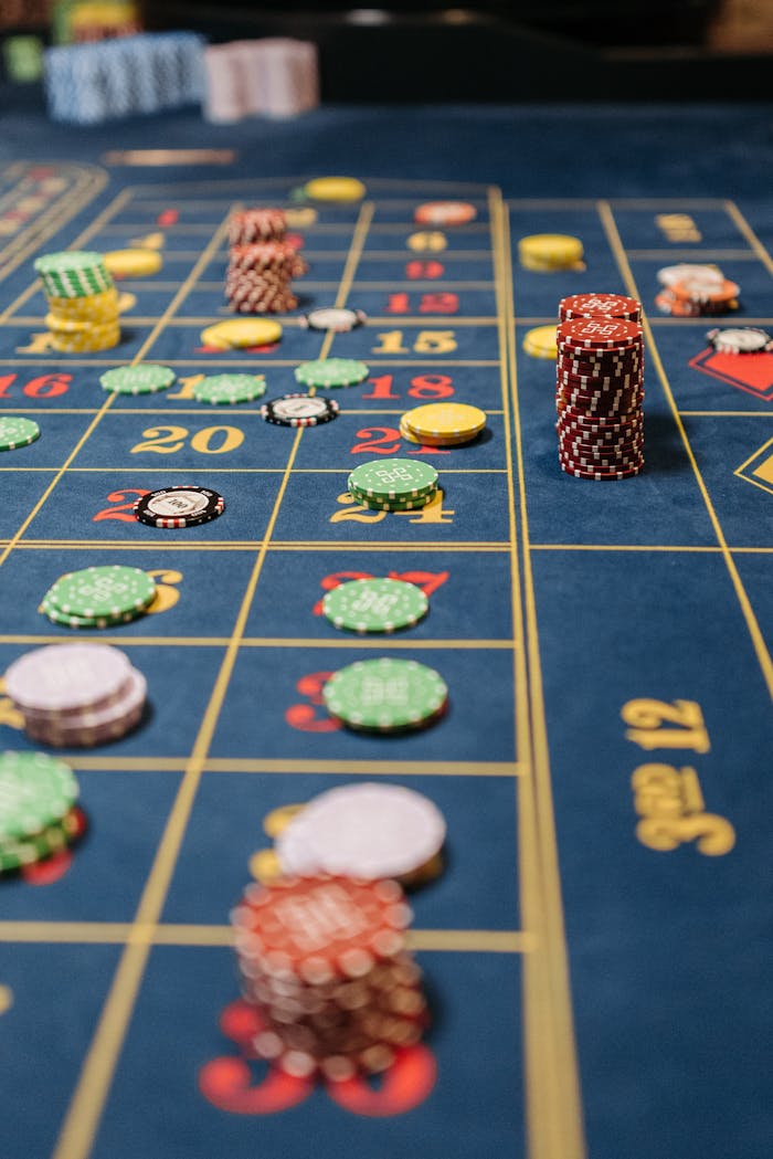 About Close-up of a roulette table with stacks of colorful chips during a game.
